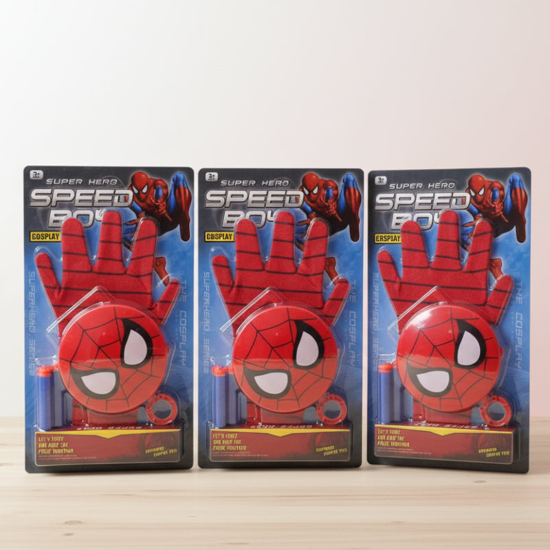 Three Spider-Man cosplay gloves in packaging on a wooden surface with a white wall background.