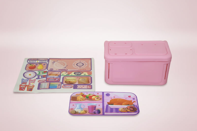 Pink toy kitchen appliance on a wooden surface with colorful labels