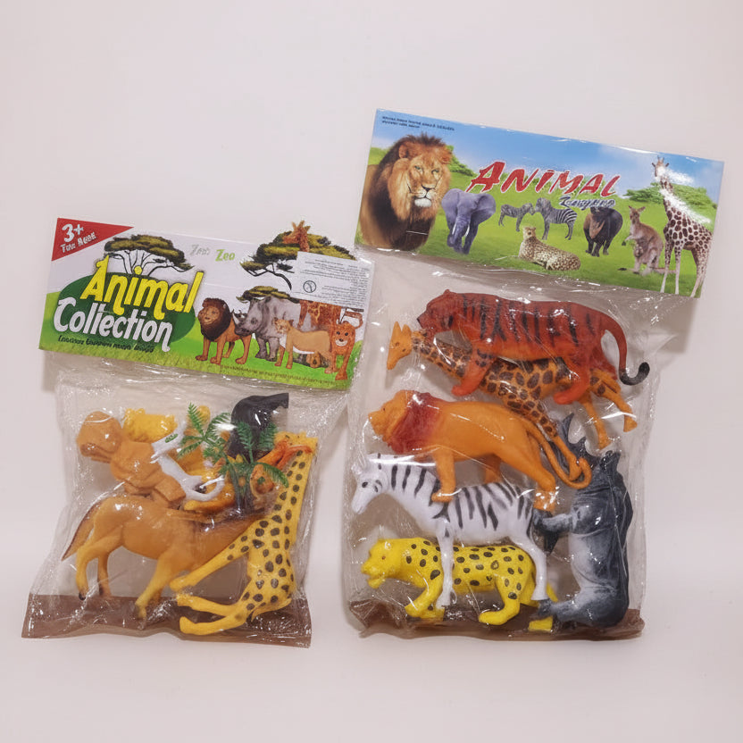 Toy animal figures in clear packaging with colorful labels on a wooden surface.