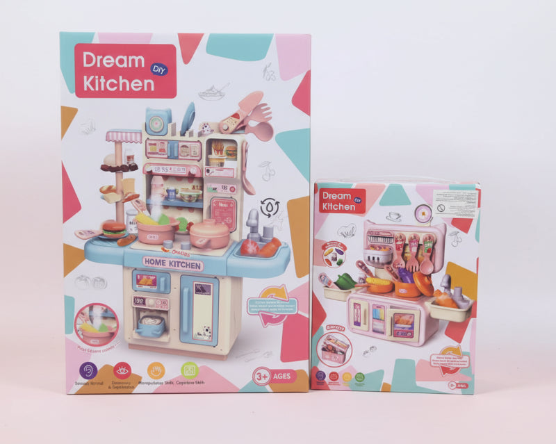 Two boxes of 'Dream Kitchen' toy sets on a wooden surface with a light-colored wall background.