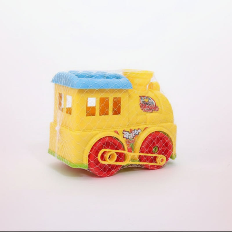 Toy train set in packaging on a wooden surface with a plain background