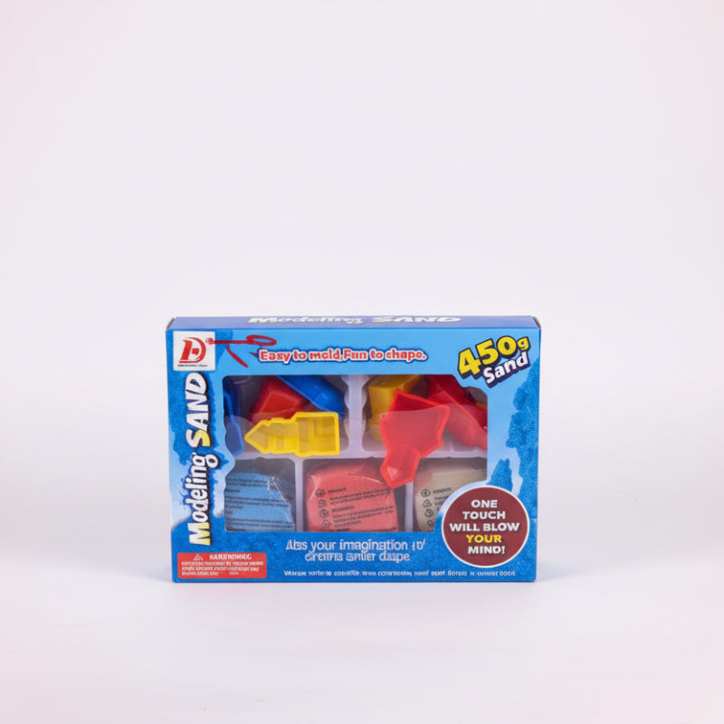 Box of modelling sand on a wooden surface with a white wall background