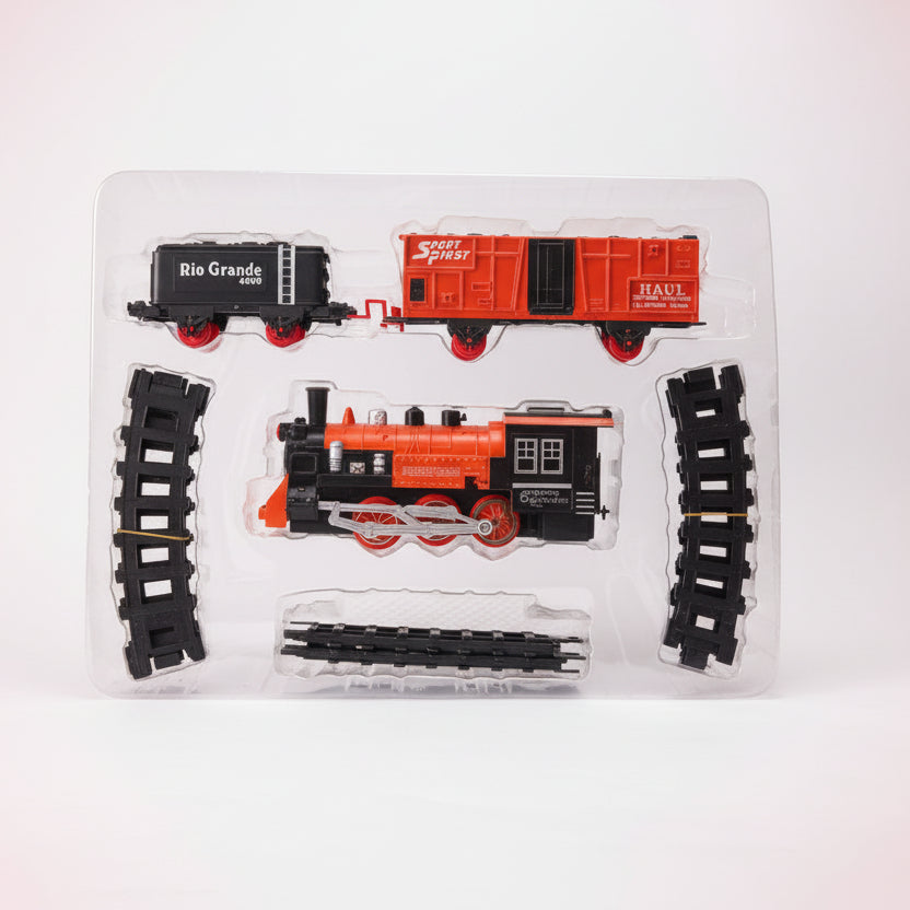 Model train set with locomotive and car in packaging on a wooden surface.