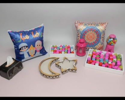Decorative items including pillows, a lantern, and small boxes on a dark surface.