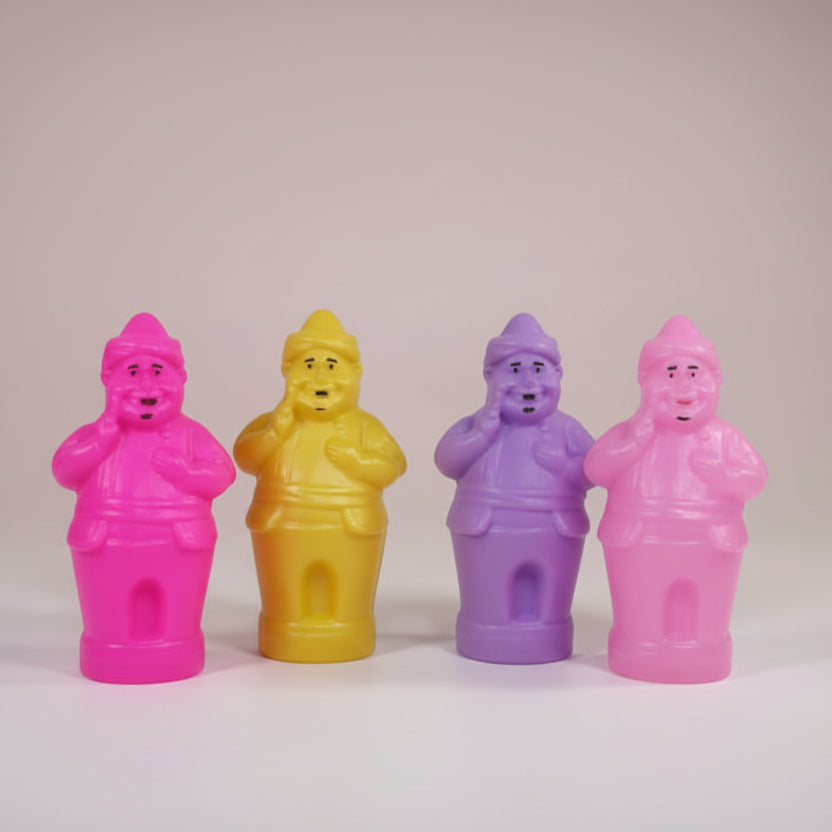 Four colorful figurines of a man on a wooden surface with a plain background