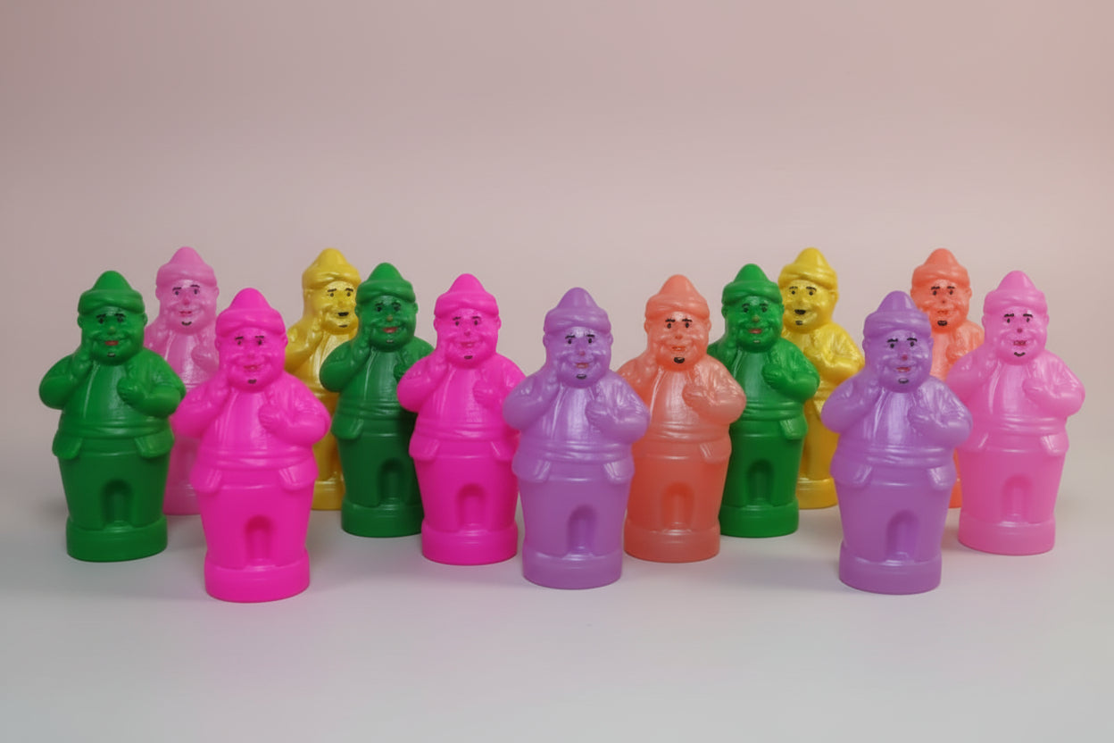 Colorful plastic figures on a wooden surface with a neutral background