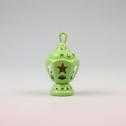 Green decorative lantern on a stick with a blurred background