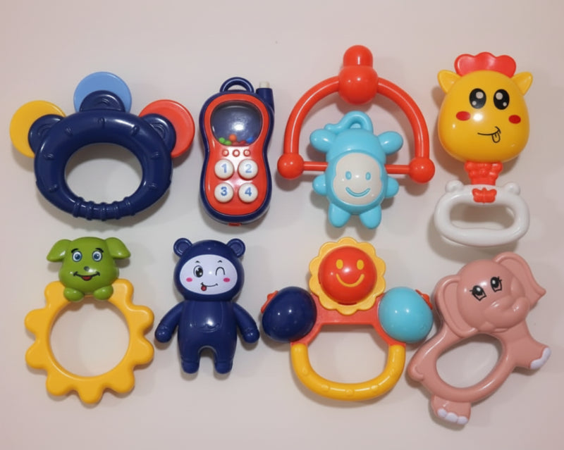 Set of colorful baby toys in a clear packaging box.