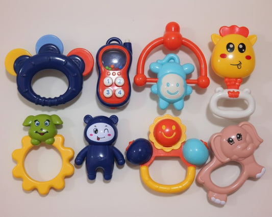 Set of colorful baby toys in a clear packaging box.