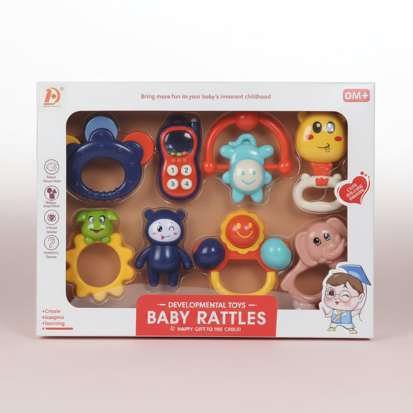 Box of developmental baby rattles with various toys on a beige background