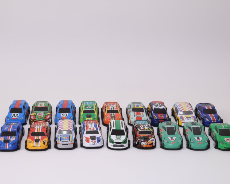 Collection of colorful toy race cars on a wooden surface