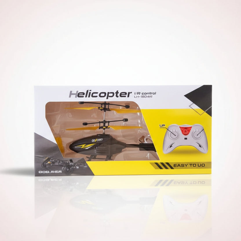 Boxed remote control helicopter with a controller on a wooden surface