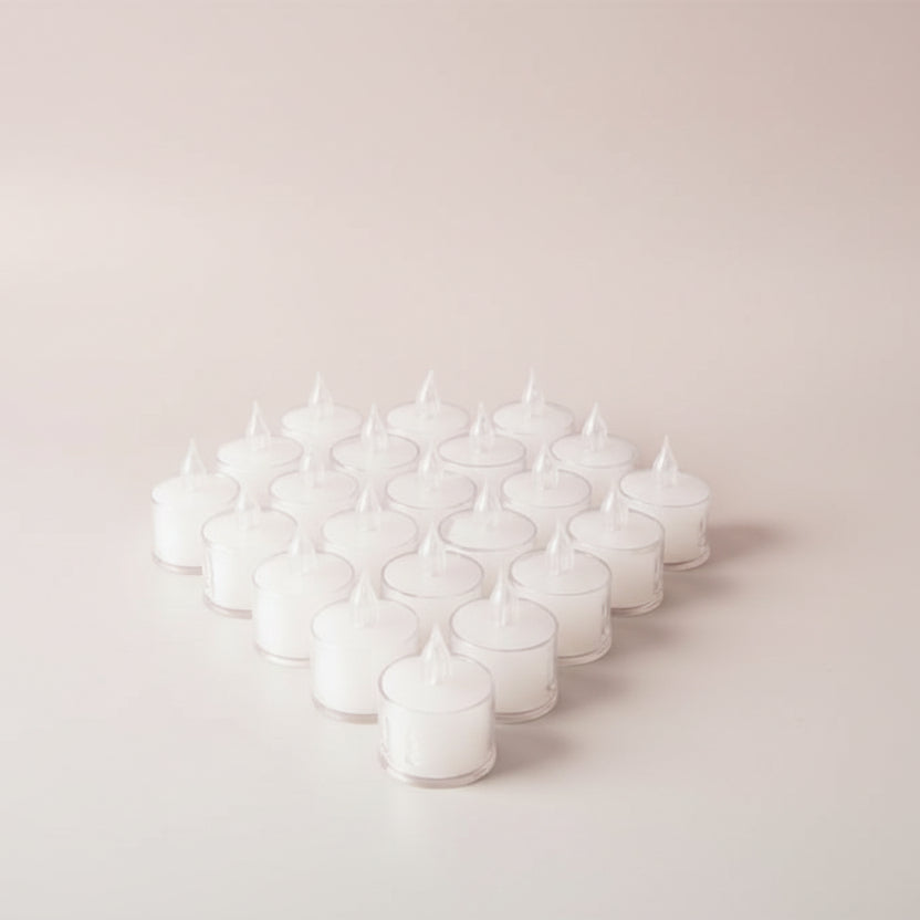 Multiple small clear containers with lids on a wooden surface