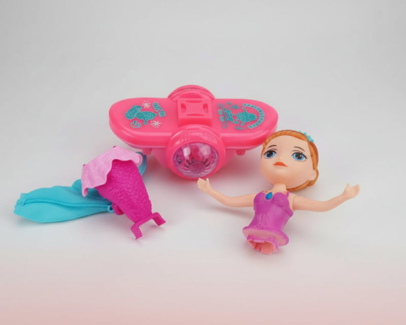 Toy mermaid figure with pink tail and blue top, and a princess doll on a wooden surface.