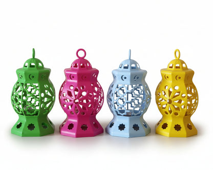 Four colorful ceramic lanterns on a wooden surface with a plain background