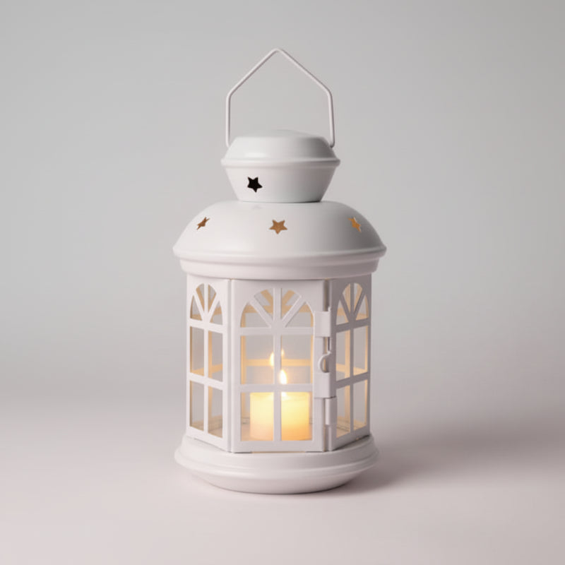 White lantern with a warm glow on a wooden surface against a beige wall