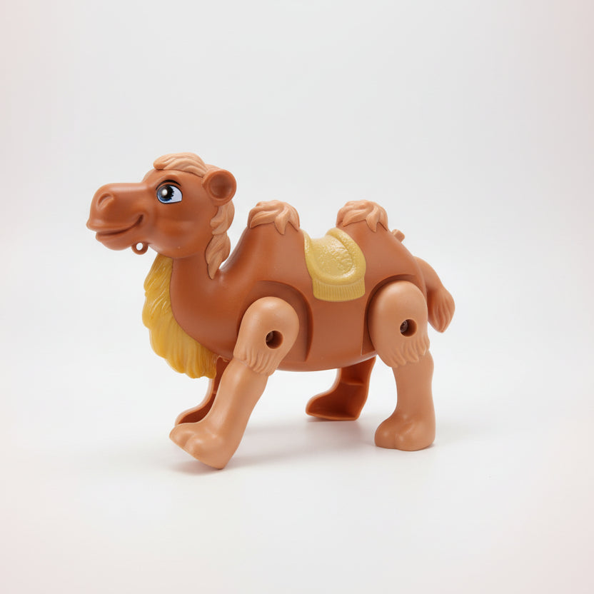 Toy camel on a wooden surface with a plain background