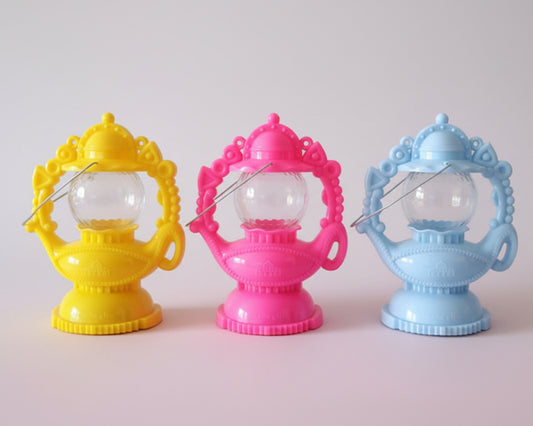 Three colorful decorative items on a wooden surface with a neutral background