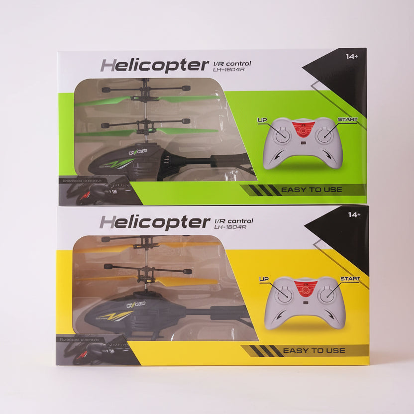 Two boxes of a helicopter IR control toy with remote on a wooden surface.