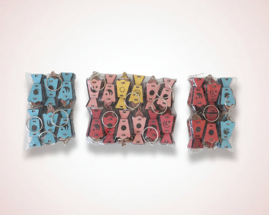 Set of keychains in clear packaging on a wooden surface