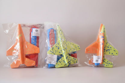 Colorful butterfly-shaped toys in clear packaging on a wooden surface.