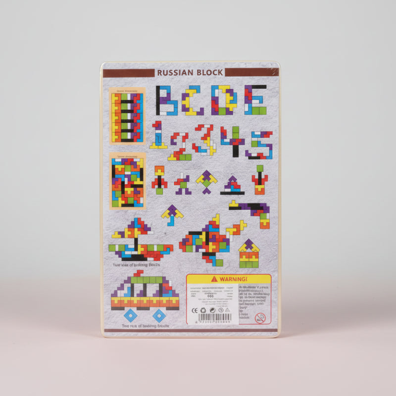 Packaging of Russian Block building blocks with colorful geometric shapes and letters on a wooden surface.