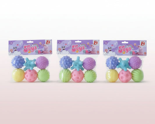 Colorful textured balls in packaging on a wooden surface with a neutral background