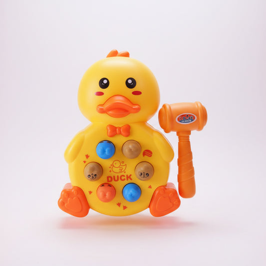 Toy duck with a hammer and packaging labeled 'Whack-A-Mole' on a wooden surface.