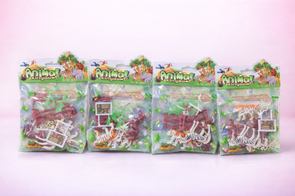 Four packages of 'Animal Kingdom' toys on a pink background