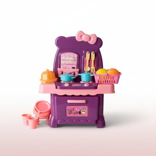 Pink toy kitchen set in clear packaging on a wooden surface with a light-colored wall background.