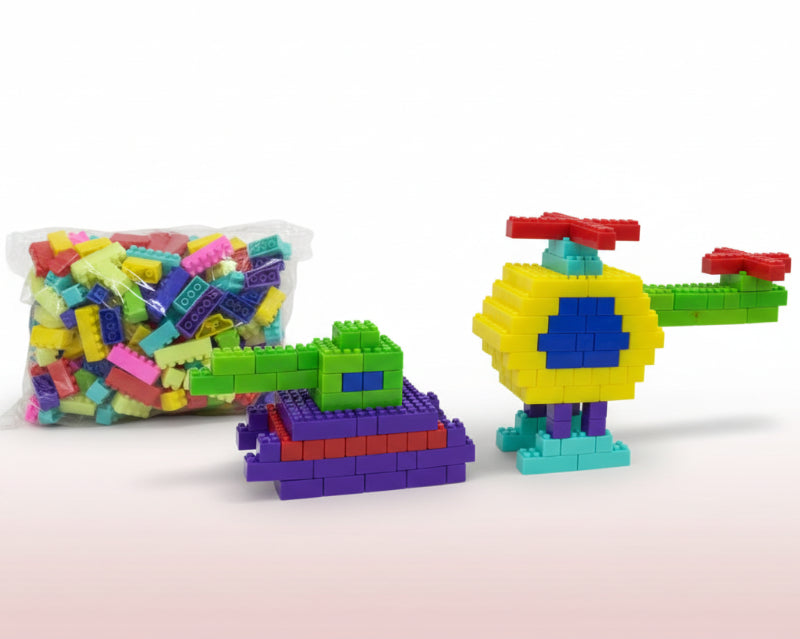 Colorful toy building blocks on a wooden surface with a white background
