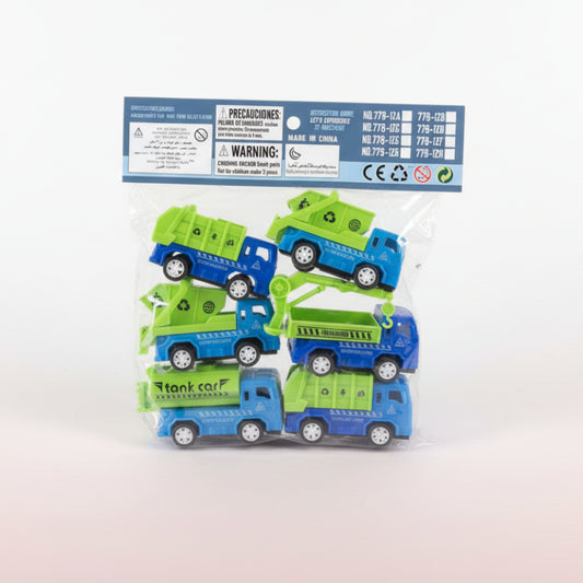 Packaged toy garbage trucks with warning labels on a wooden surface