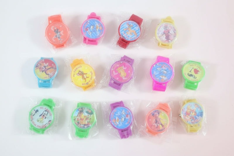 Colorful children's watches in clear packaging on a wooden surface