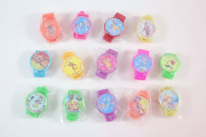 Colorful children's watches in clear packaging on a wooden surface