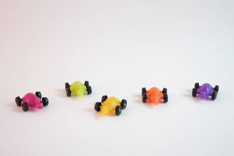 Colorful toy cars on a wooden surface