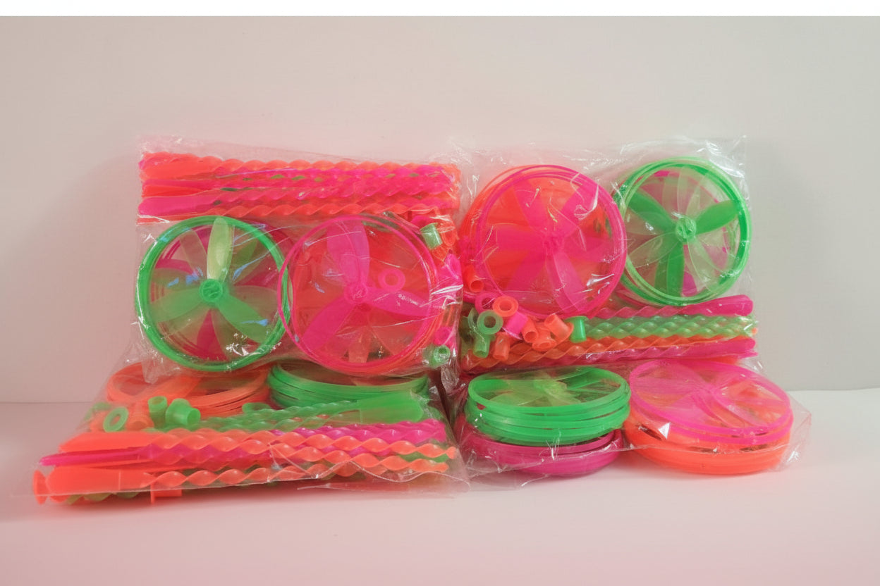 Colorful plastic toys with wheels on a wooden surface