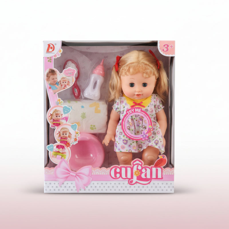 Toy doll with accessories in a transparent packaging box on a wooden surface.