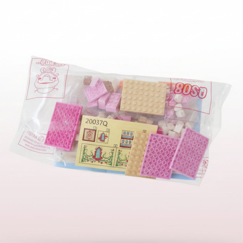 Box containing stationery items including envelopes and a pink letter opener on a wooden surface.