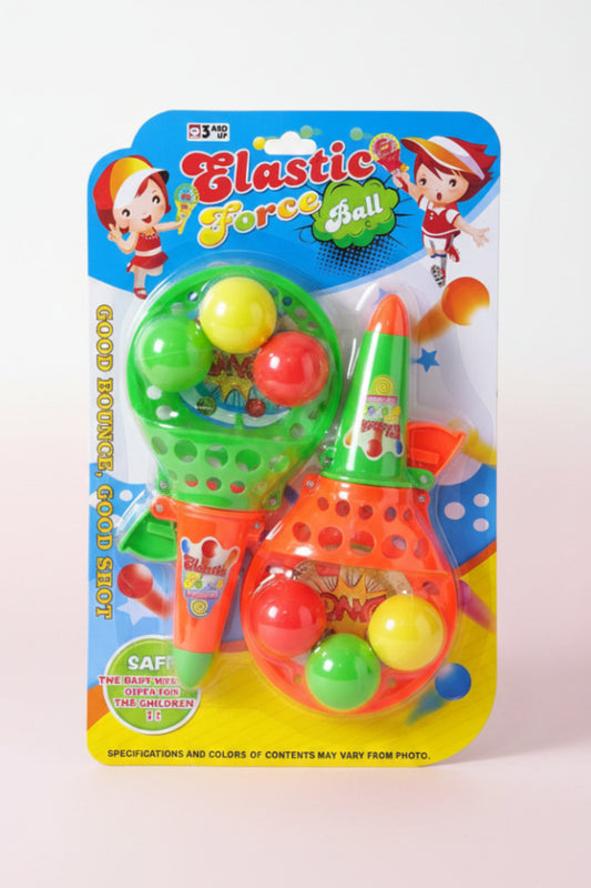 Colorful toy set with 'Elastic Force Ball' packaging on a wooden surface.