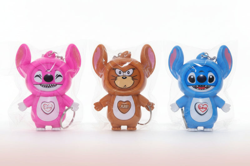 Three cartoon character figurines in clear packaging on a wooden surface.