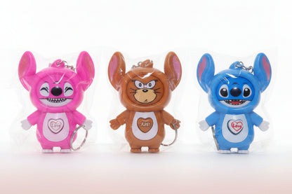 Three cartoon character figurines in clear packaging on a wooden surface.