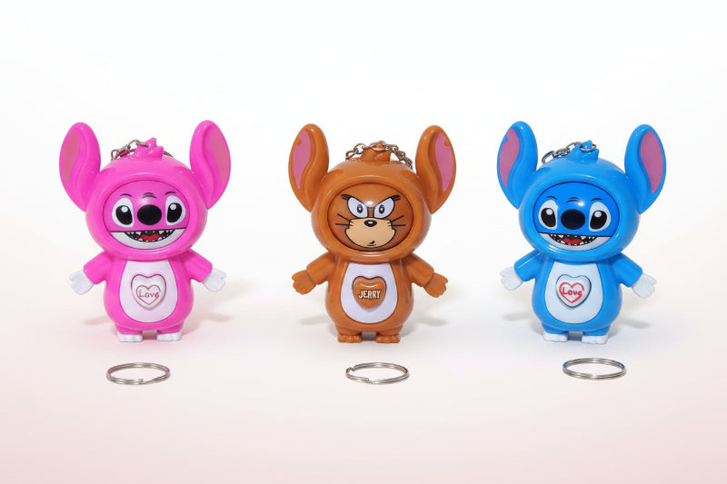 Three colorful cartoon character figurines on a wooden surface with rings in front.