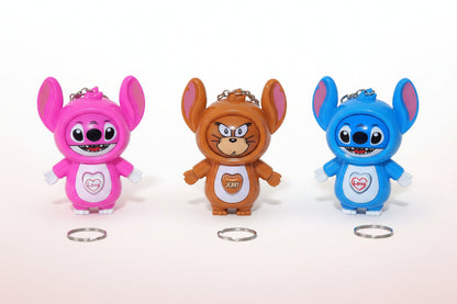 Three colorful cartoon character figurines on a wooden surface with rings in front.