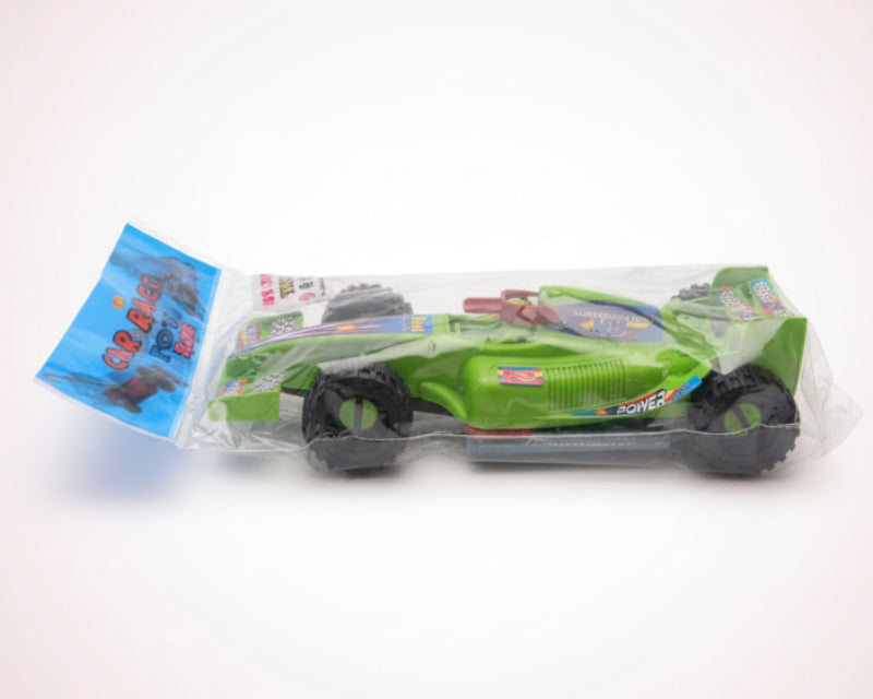 Toy car in packaging on a wooden surface with a white wall background
