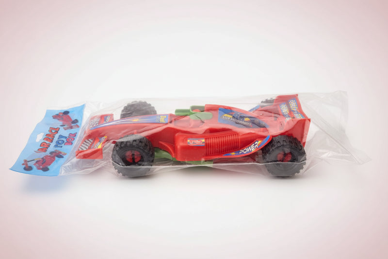 Toy car in packaging on a wooden surface