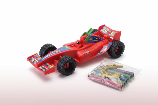 Red toy race car with a package of colorful plastic rings on a wooden surface.