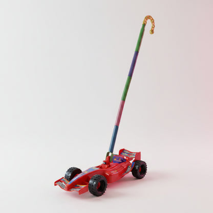 Toy lawn mower with colorful design on a wooden surface