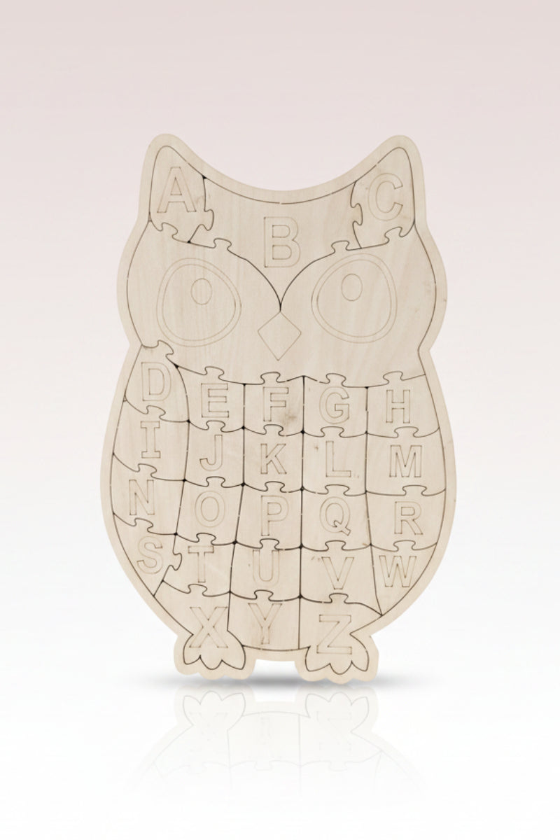 Wooden owl-shaped alphabet puzzle on a dark surface