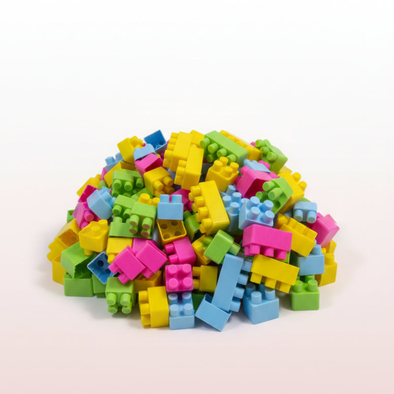 Colorful building block toys in a clear plastic bag on a textured surface