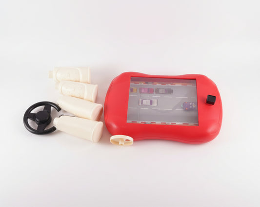 Red electronic device with screen and control buttons on a wooden surface